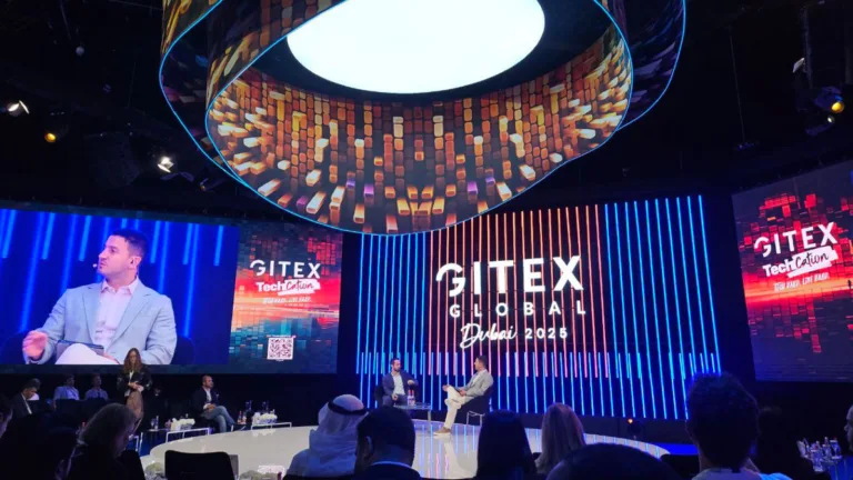 Panel discussion at GITEX Global 2025 in Dubai highlighting the AI revolution on a futuristic tech stage