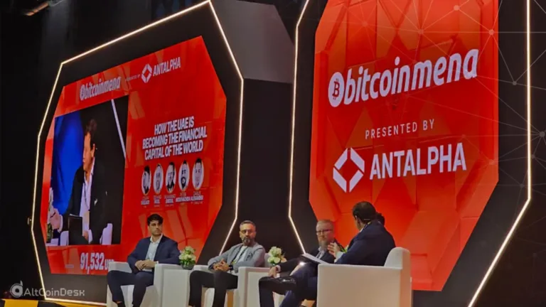 Day 1 of Bitcoin MENA panel discussion on stage with speakers and event branding.