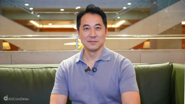 An image of Vincent Chok, founder of First Digital Trust sitting on a sofa
